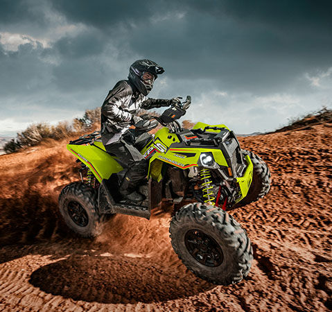 A rider easily cornering with a 2025 Polaris Scrambler XP 1000 S Sport ATV thanks to the customizable multi-select electronic power steering (EPS).