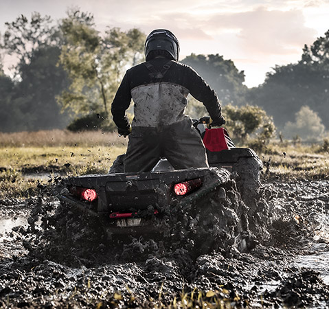 A rider on a 2025 Polaris Sportsman Mud Edition ATV deep in the mud.