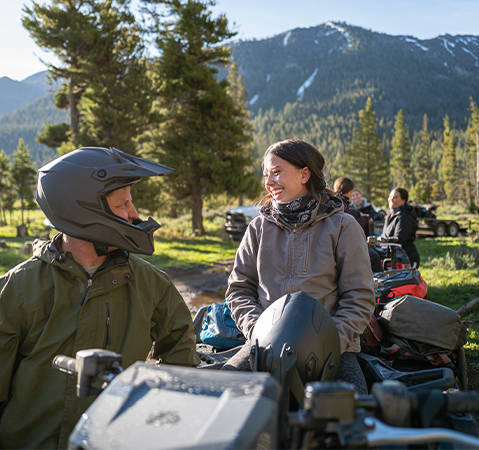 Woman smiling from the passenger seat of a 2025 Polaris Sportsman Touring 570 2-up ATV.