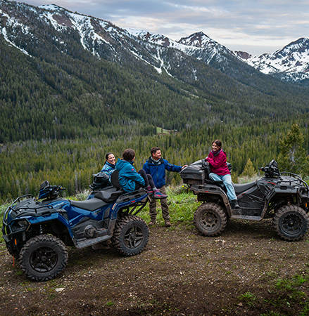4 riders exploring the unexplored with their 2025 Polaris Sportsman Touring 570 2-up ATV featuring 26-inch DURO tires and 14-inch aluminum wheels.
