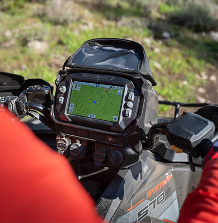 A 7-inch RIDE COMMAND touch screen display installed on a 2025 Polaris Sportsman Touring 570 2-up ATV.