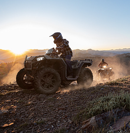 2 riders on 2025 Polaris Sportsman XP 1000 ATVs showcasing the high-output LED headlights.