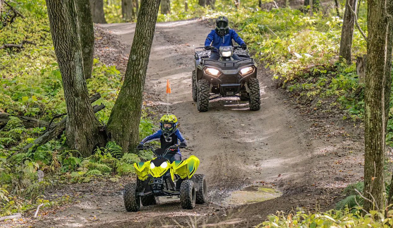 A kd leading the way on his 2026 Polaris Outlaw 110 EFI youth ATV.