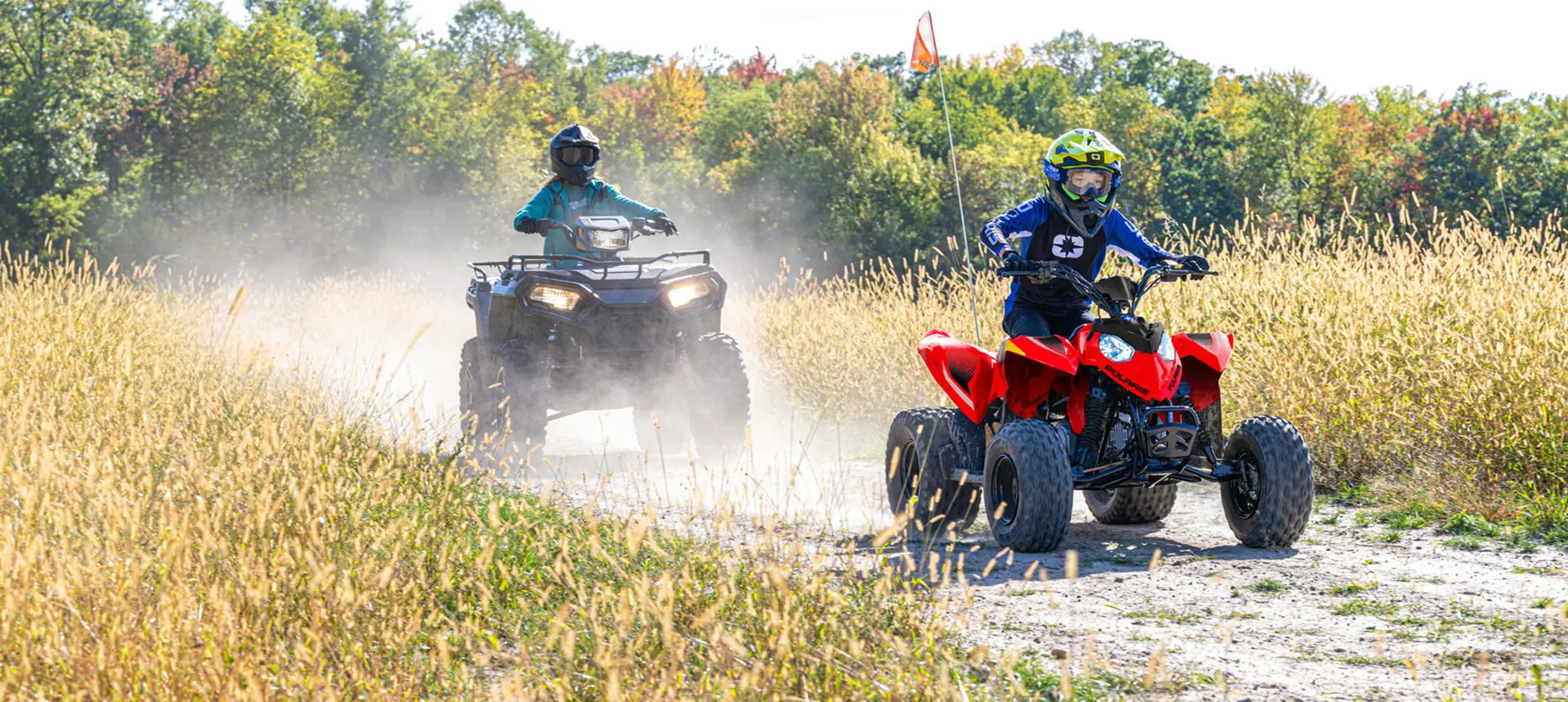 A girl having fun on her 2026 Polaris Outlaw 110 EFI youth ATV.