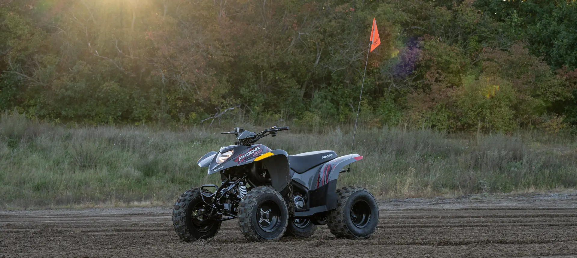 A Storm Gray 2026 Polaris Phoenix 200 youth ATV parked and ready to be ride.