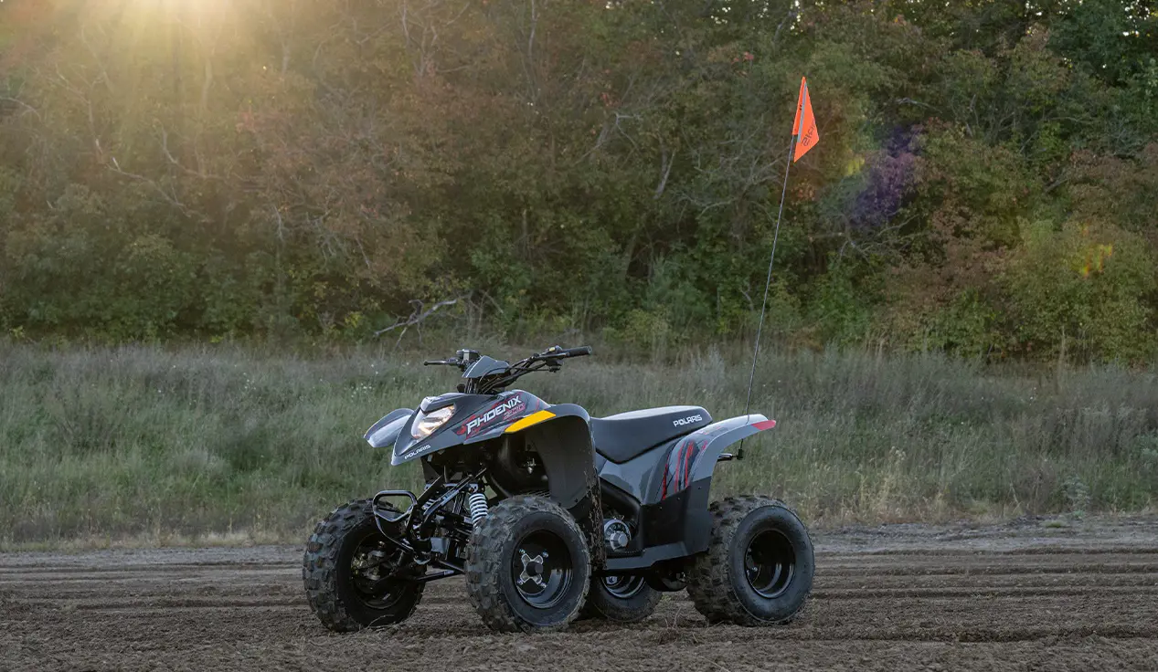 A Storm Gray 2026 Polaris Phoenix 200 youth ATV parked and ready to be ride.