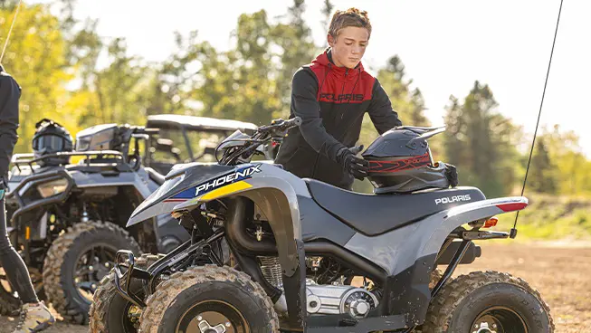 4 Polaris youth ATVs in a lineup including the 2026 Polaris Phoenix 200 youth ATV.