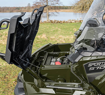 Sealed storage under the front cargo rack on a 2026 Polaris Sportsman 570 ATV.