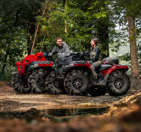 2 riders on two 2026 Polaris Sportsman Mud Edition ATVs showcasing the 13.5-inches of ground clearance.