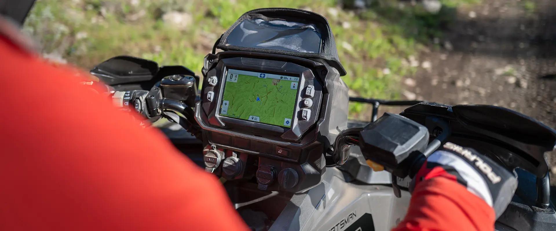 Over-the-shoulder view of a the RIDE COMMAND screen on the handlebars of a 2026 Polaris Sportsman Touring 570 2-up ATV.