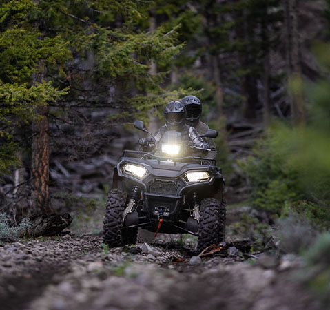 2 riders on a 2-up 2026 Polaris Sportsman X2 570 ATV showcasing the new LED pod and headlights.