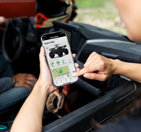 Person using the RIDE COMMAND app on a smart phone.