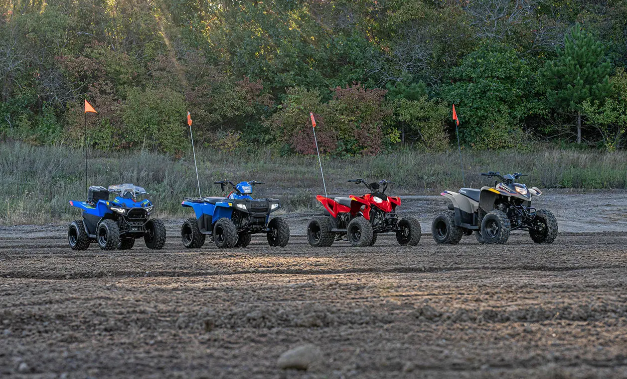 4 Polaris youth ATVs in a lineup.
