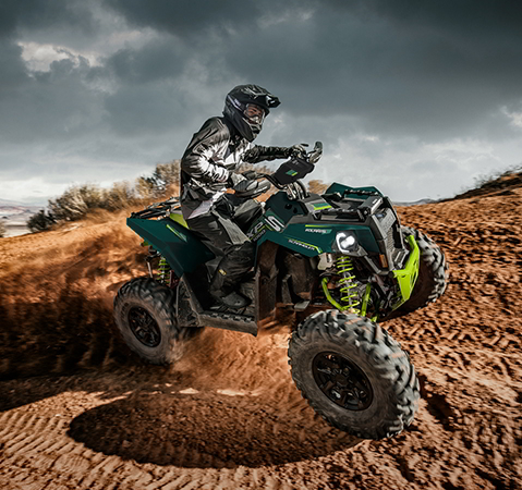Rider on a 2027 Polaris Scrambler XP 1000 S sport ATV cruising on a demanding trail.