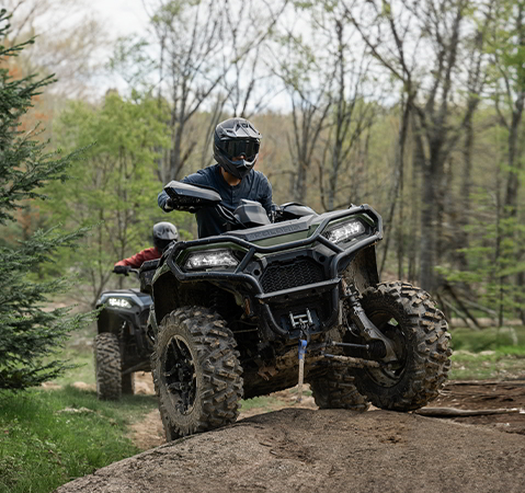 A rider on a 2027 Polaris Sportsman 500 ATV showcasing the 11.5-inches of ground clearance.