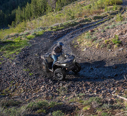A rider taking a tight corner on a 2027 Polaris Sportsman 850 ATV.
