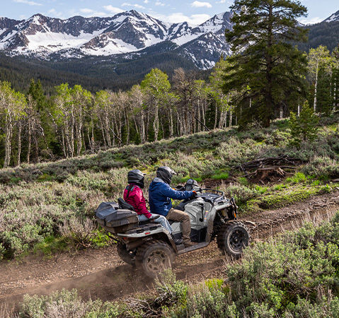 2 riders cruising a trail on their 2027 Polaris Sportsman Touring 600 2-up ATV.