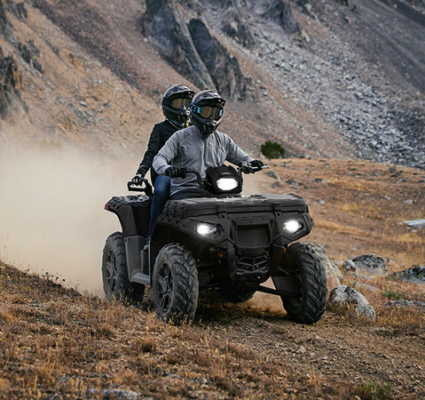 2 riders on the nimble 2027 Polaris Sportsman Touring 850 Premium 2-up ATV.