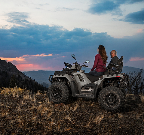 2 people overlooking a ridge from their 2027 Polaris Sportsman Touring XP 1000 Trail 2-up ATV.