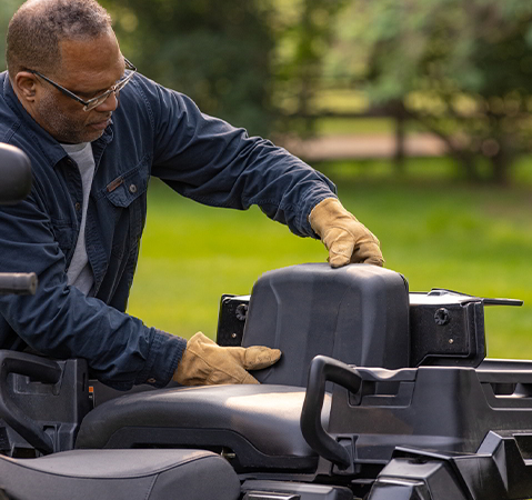 Person setting up the convertible rear seat on a 2027 Polaris Sportsman X2 600 2-up ATV.