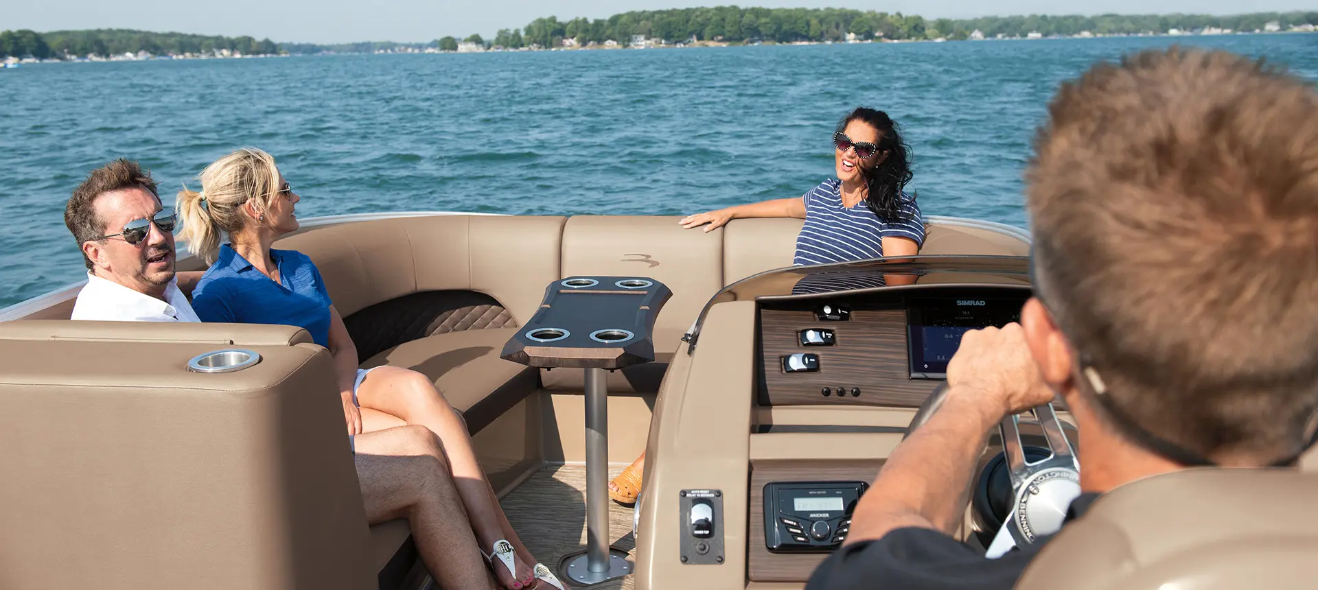 4 people cruising on a bennington l bowrider pontoon boat