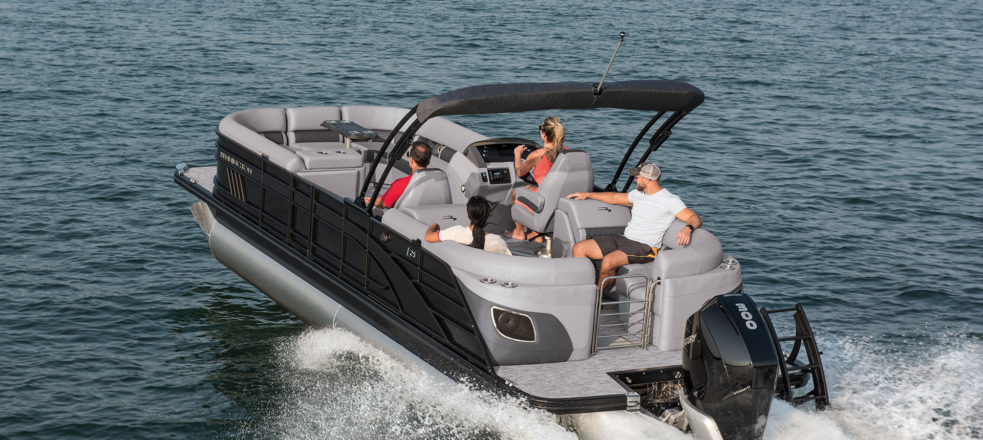 Four people on a L boat in the water