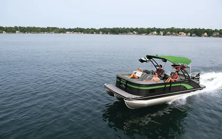 green and black bennington lx pontoon boat cruising on a lake