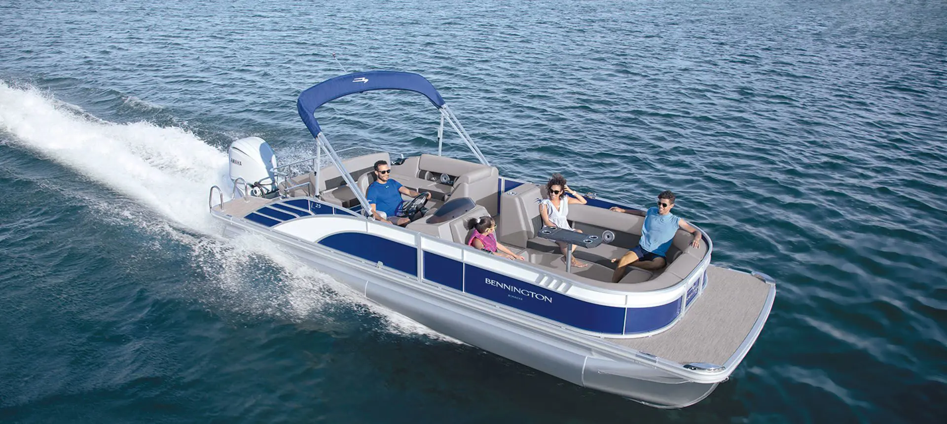 aerial view of a bennington l bowrider pontoon boat on a lake