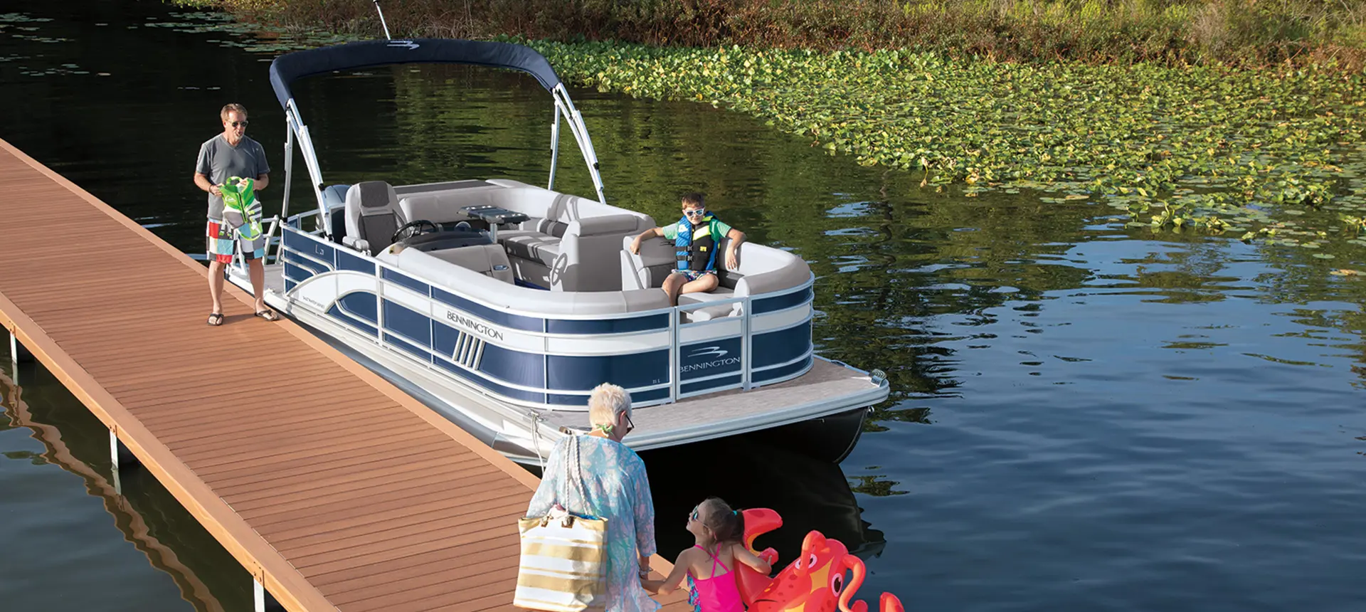 people walking towards a docked bennington l pontoon boat