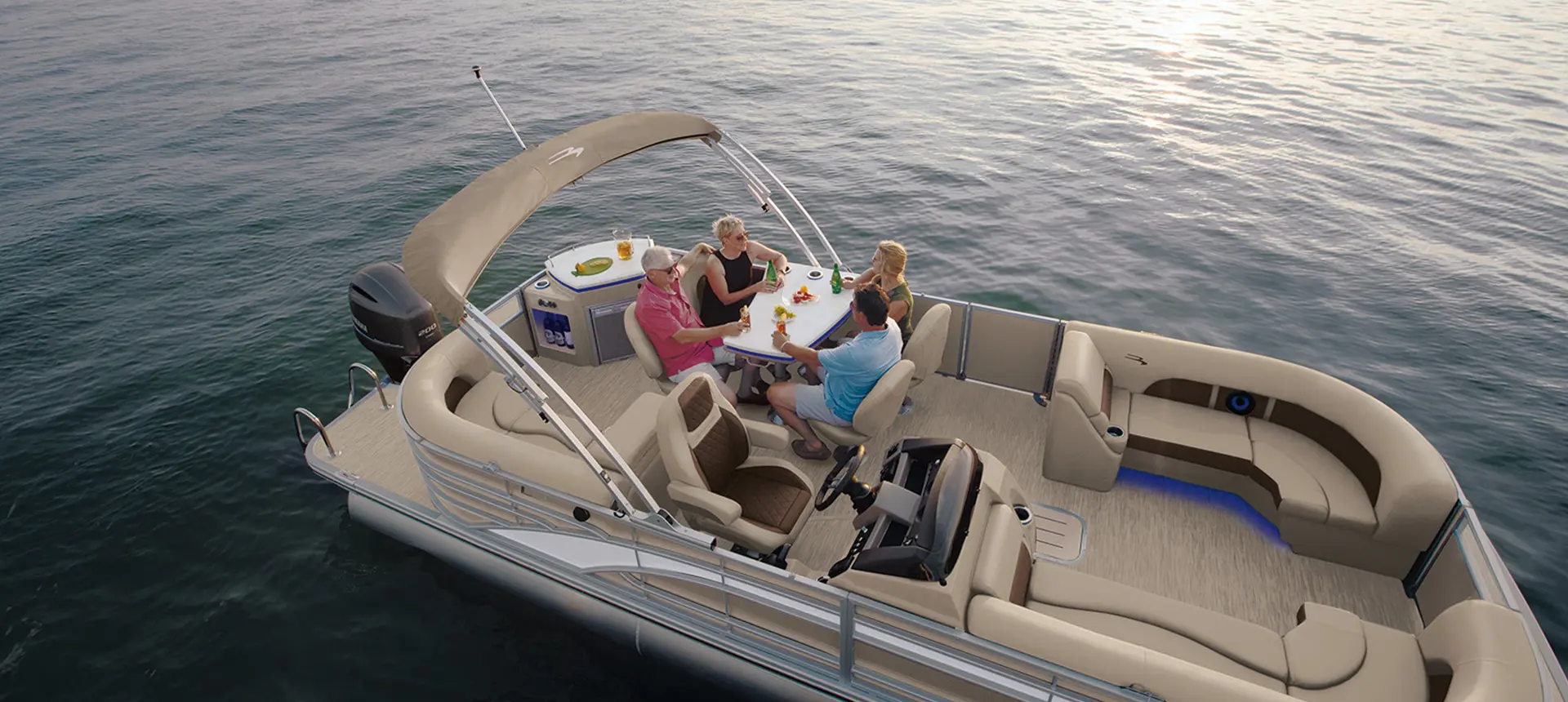 people sitting at the table on a bennington l pontoon boat with entertainment floor plan