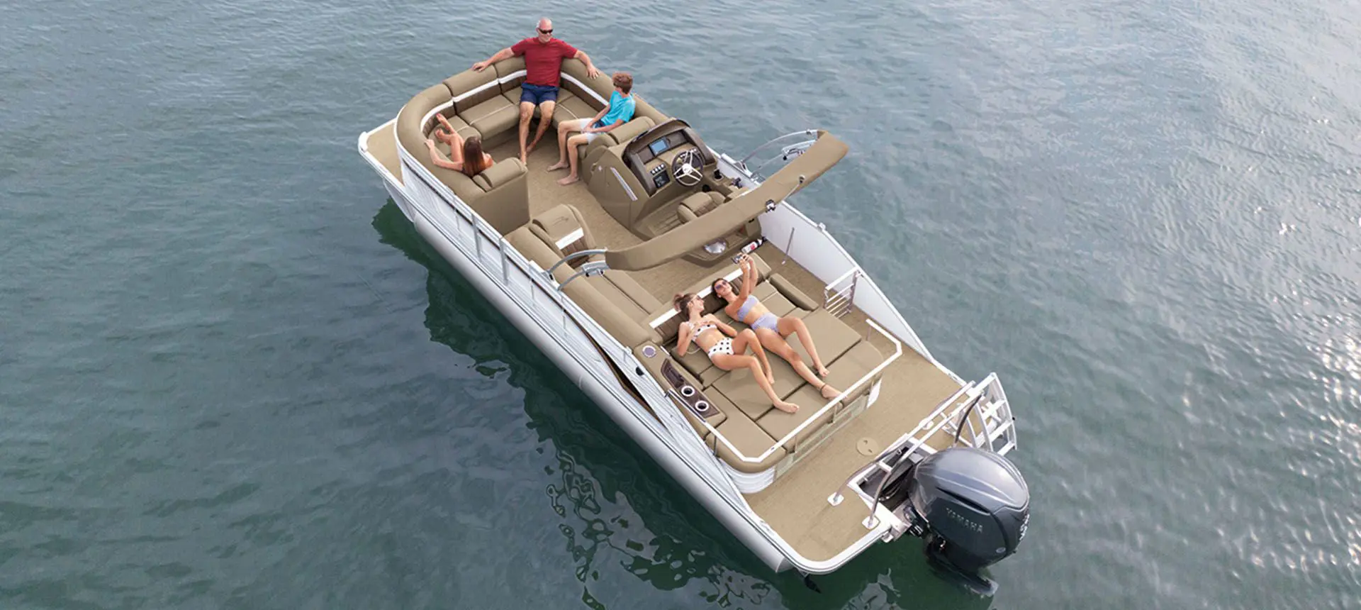 aerial view of a family relaxing on a bennington lx pontoon boat on a lake