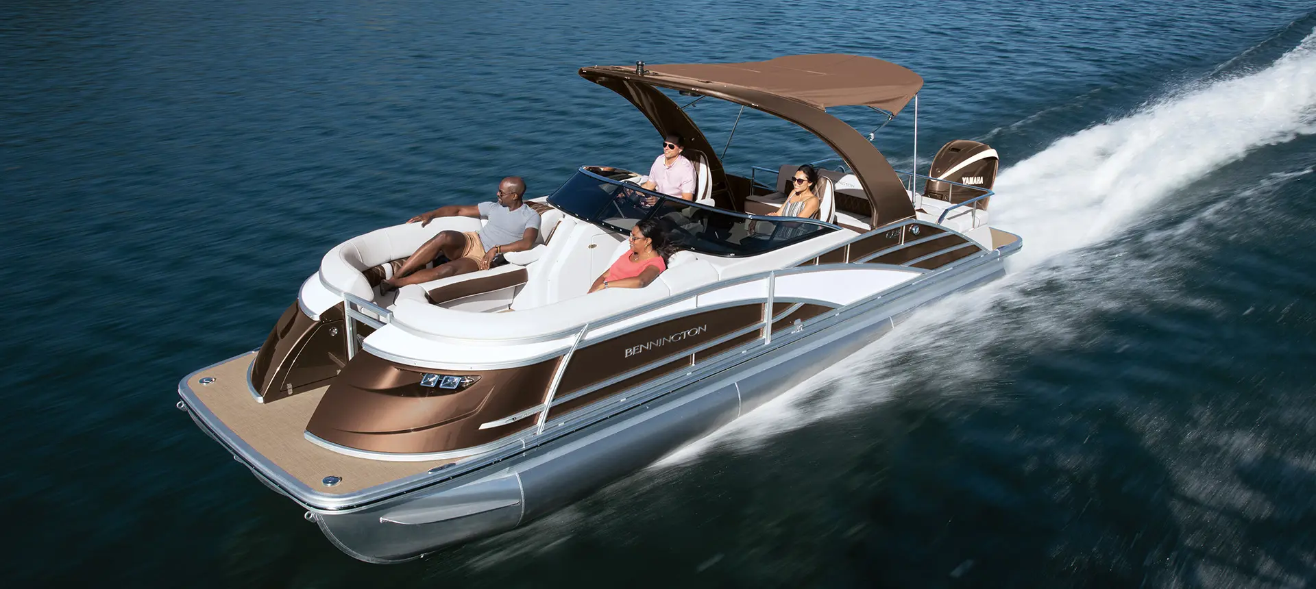 people relaxing on a bennington q pontoon boat with swingback floor plan