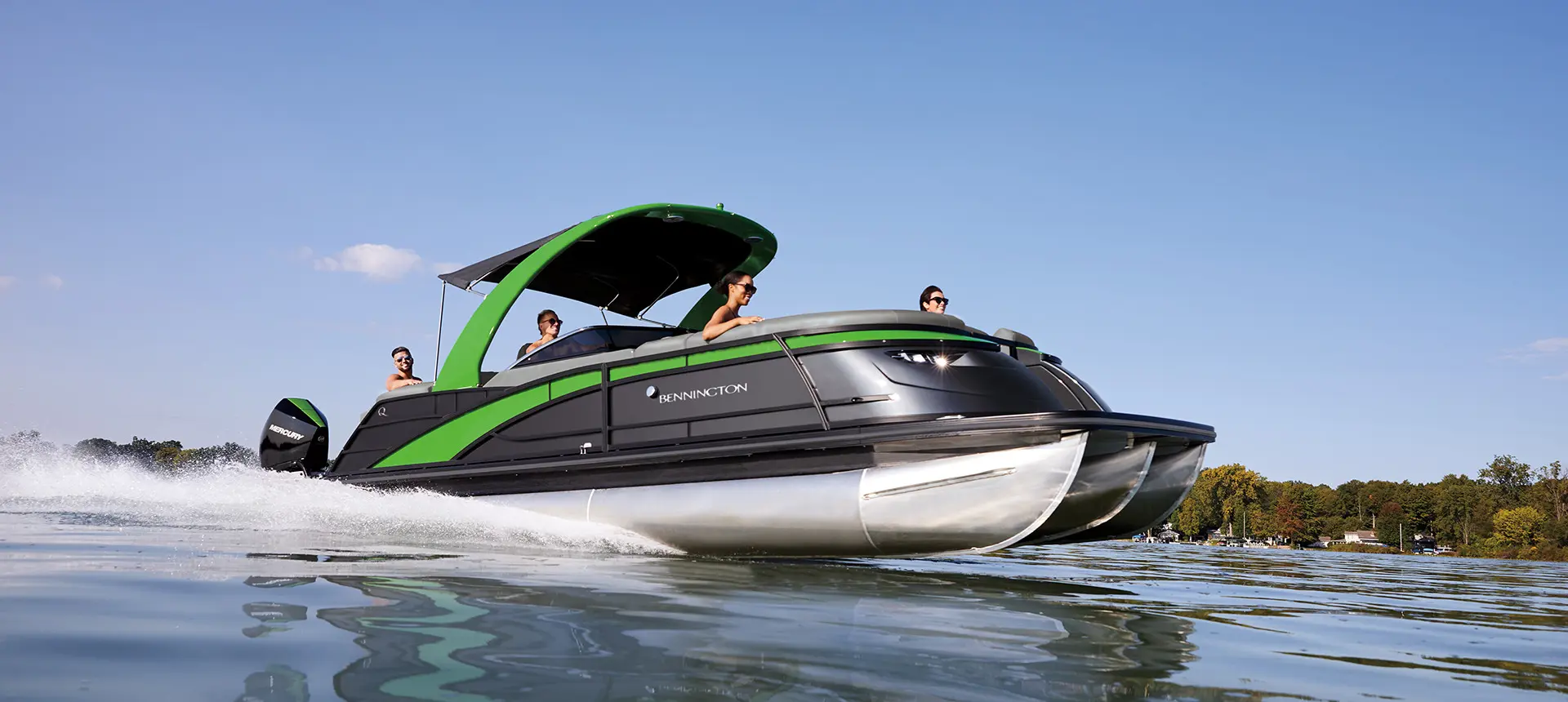 side view of a bennington q tritoon boat cruising on a lake