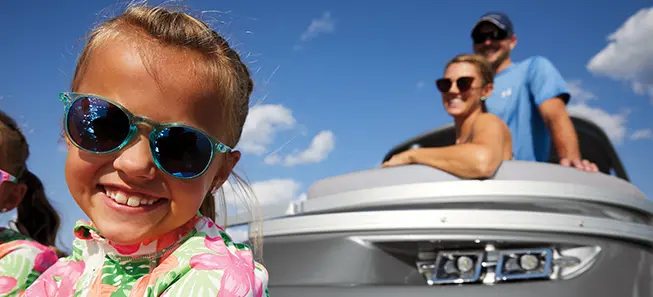 close up of a kid smiling on a Bennington Q Pontoon Boat