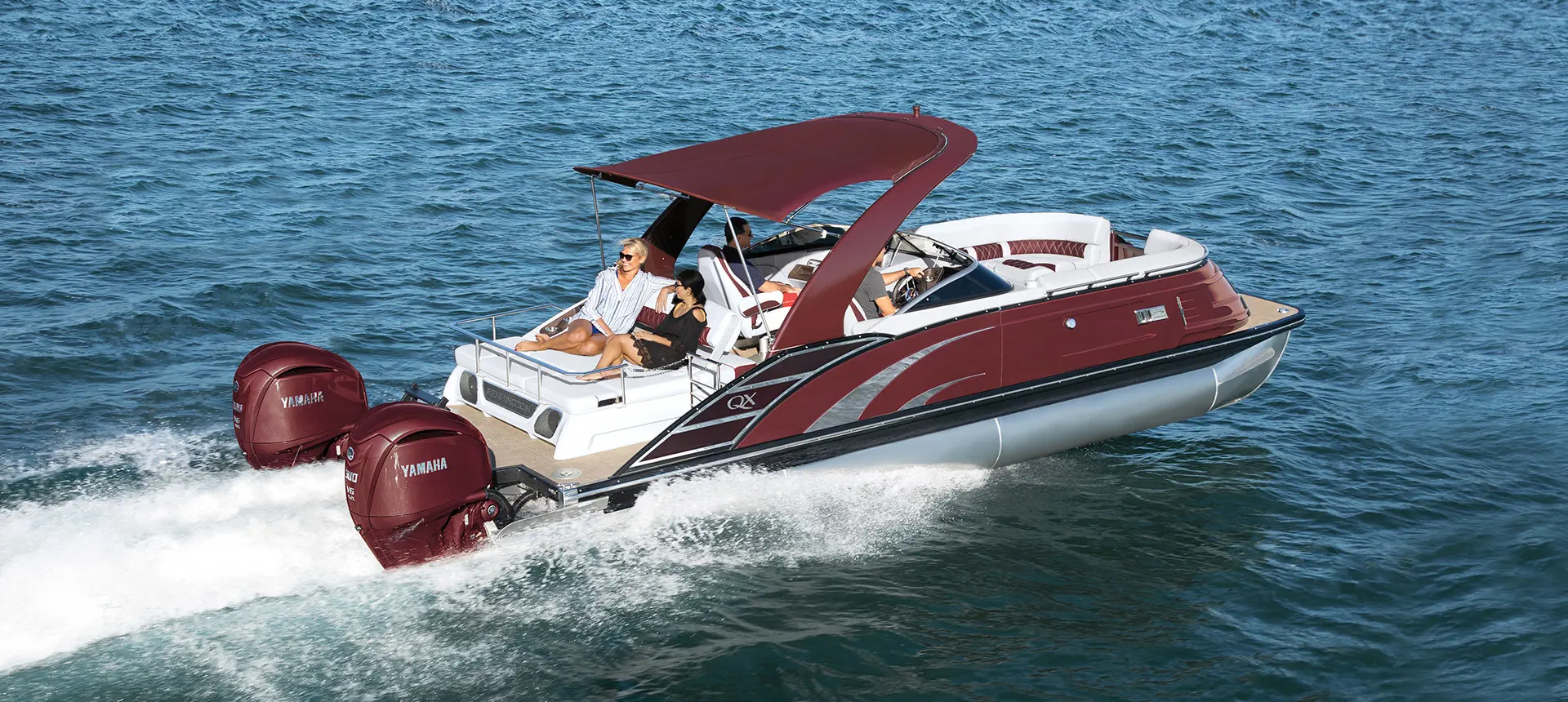 Bennington QX pontoon cruising across a lake