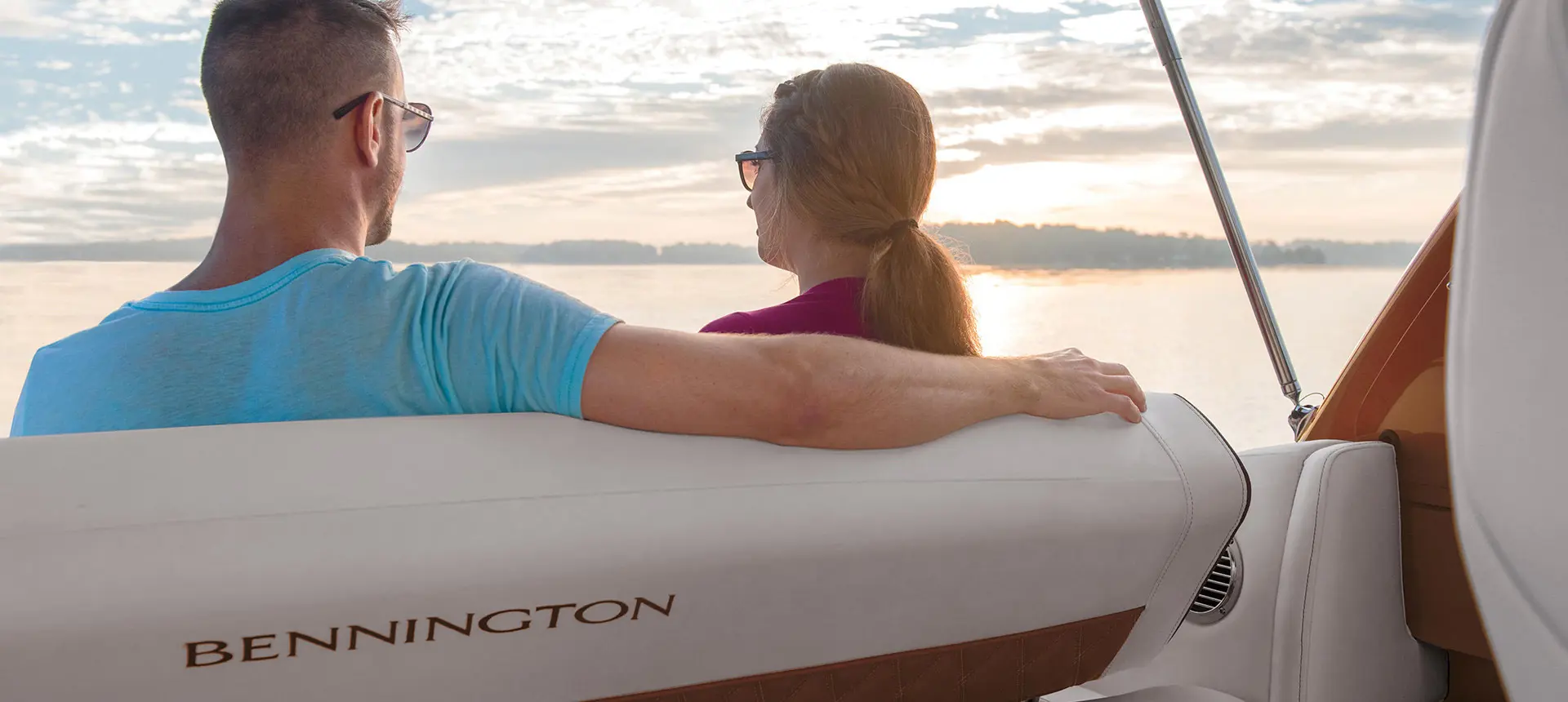 A couple enjoying the sunset on their Bennington QX pontoon