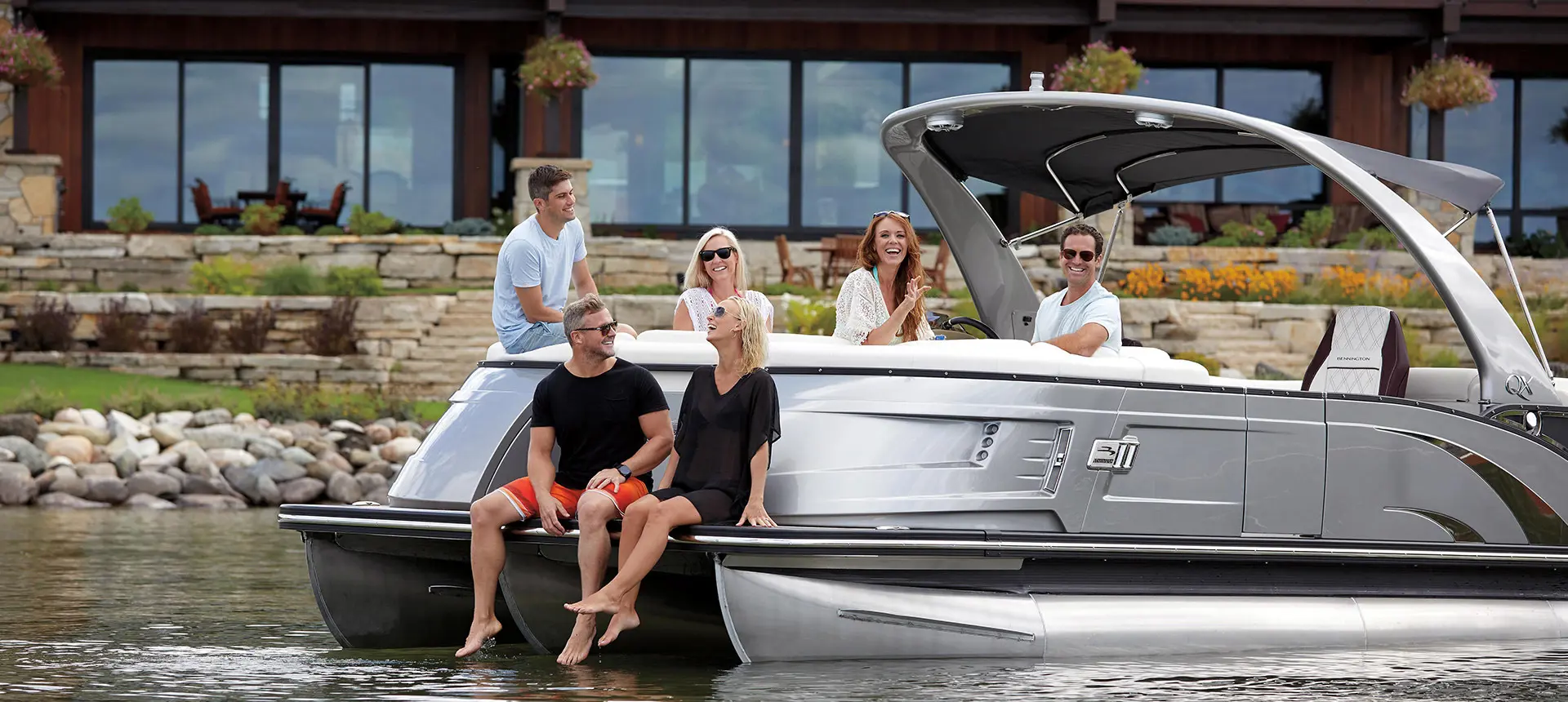 A group of friends relaxing on their Bennington QX pontoon boat