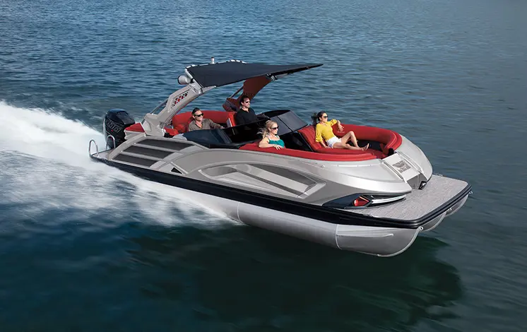 side view of a bennington qx sport pontoon boat cruising on a lake
