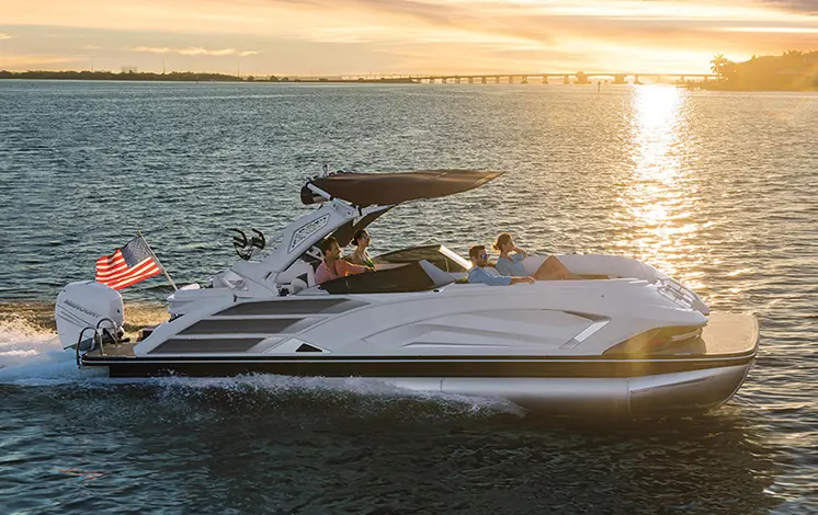 side profile of a bennington qx sport pontoon boat on a lake