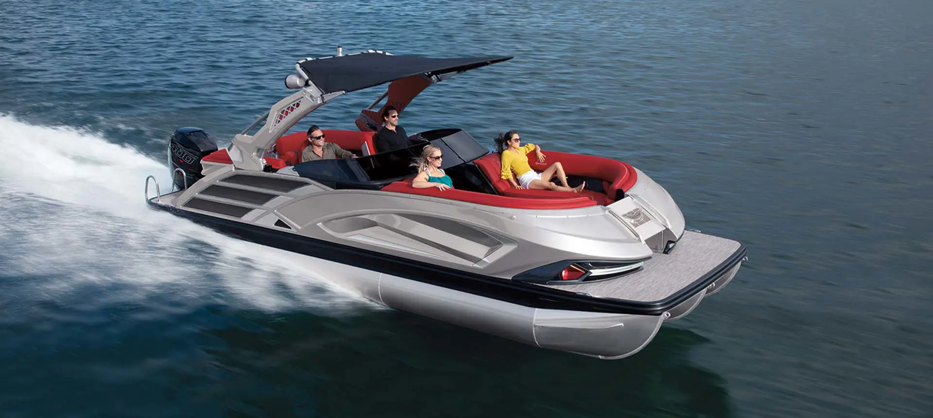 side view of a bennington qx sport pontoon boat cruising on a lake