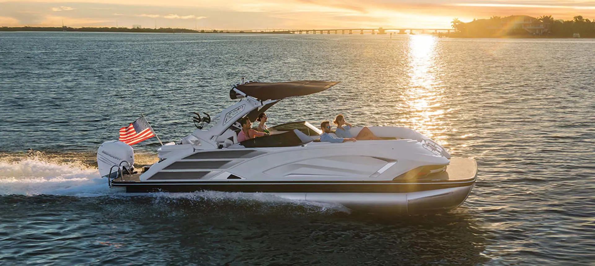 side profile of a bennington qx sport pontoon boat on a lake