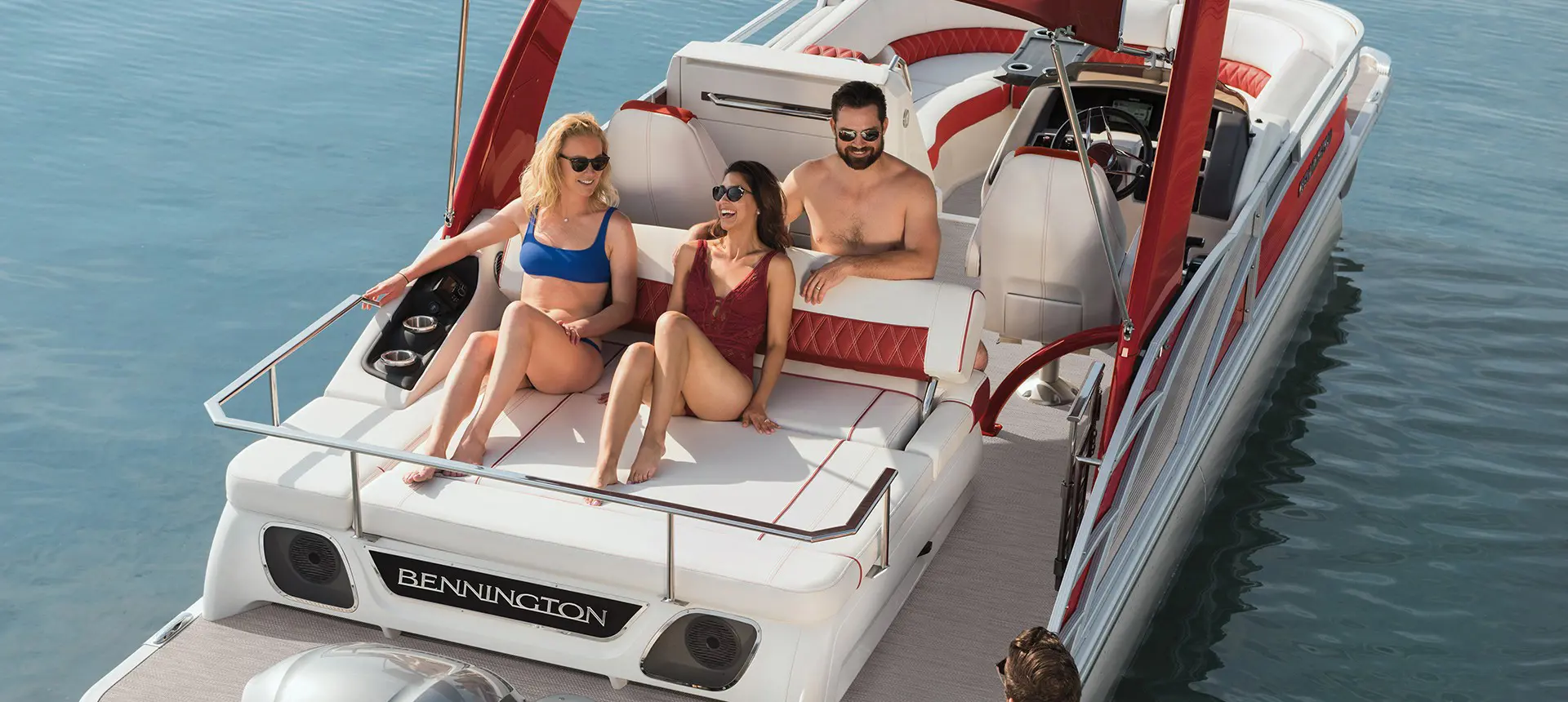 A group of friends sunbathing while riding their Bennington R Bowrider