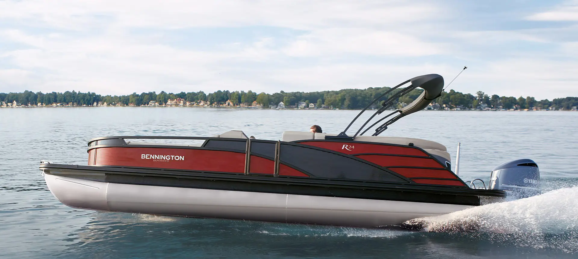 Profile view of a Bennington R Bowrider Pontoon Boat on the water