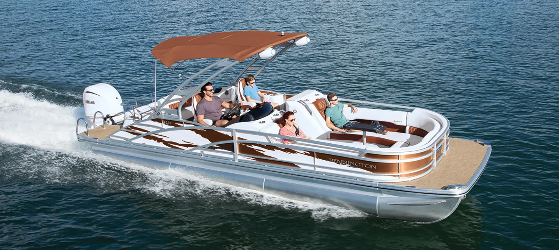 A family enjoying a ride on their Bennington R Bowrider Pontoon Boat