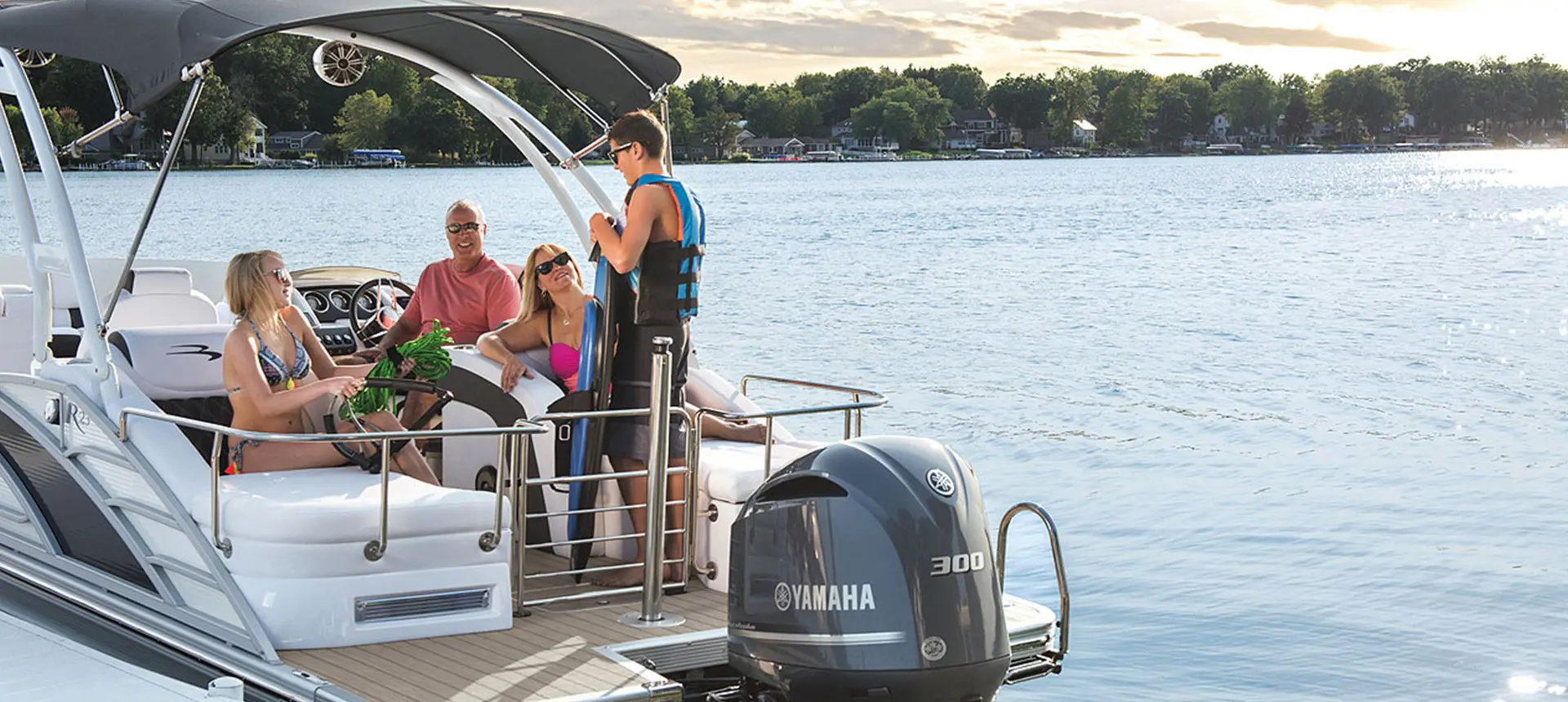 family getting read to wakeboard on a Bennington R pontoon with stern lounge floor plan