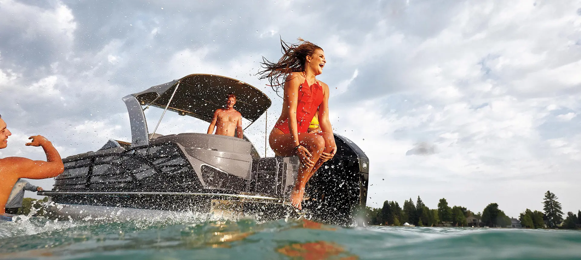 Woman jumping to the water from a Bennington R pontoon