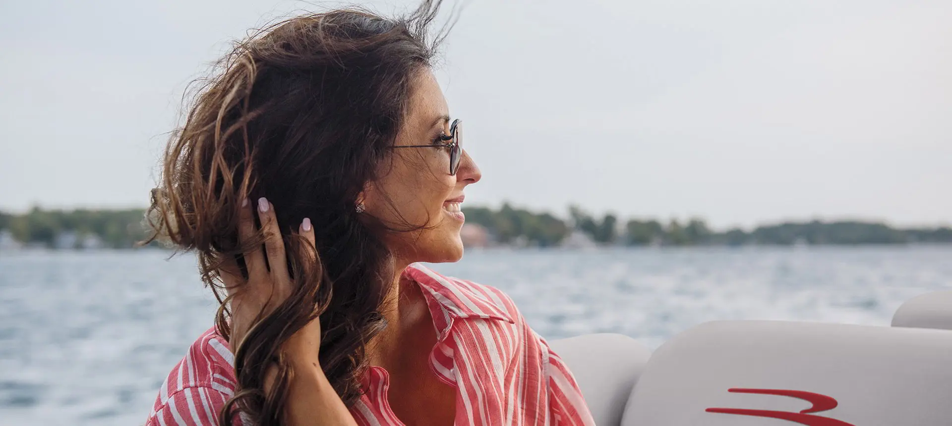 woman enjoying the breeze on a Bennington R pontoon