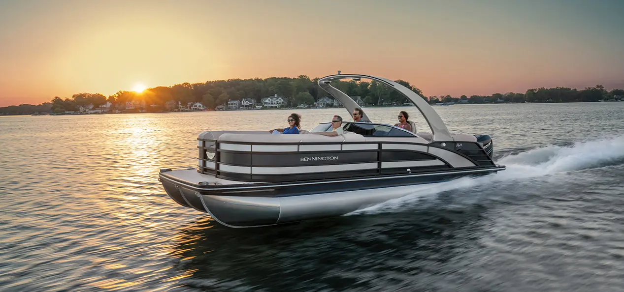 group of people enjoying sunset in a Bennington R pontoon in a lake