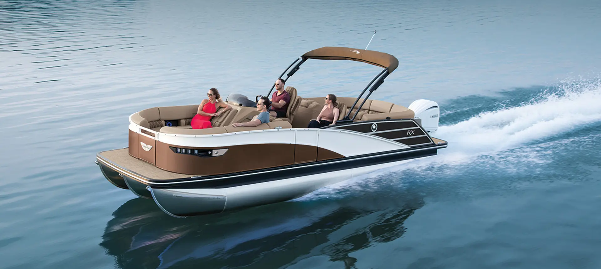 A family riding their Bennington RX Sport in the water