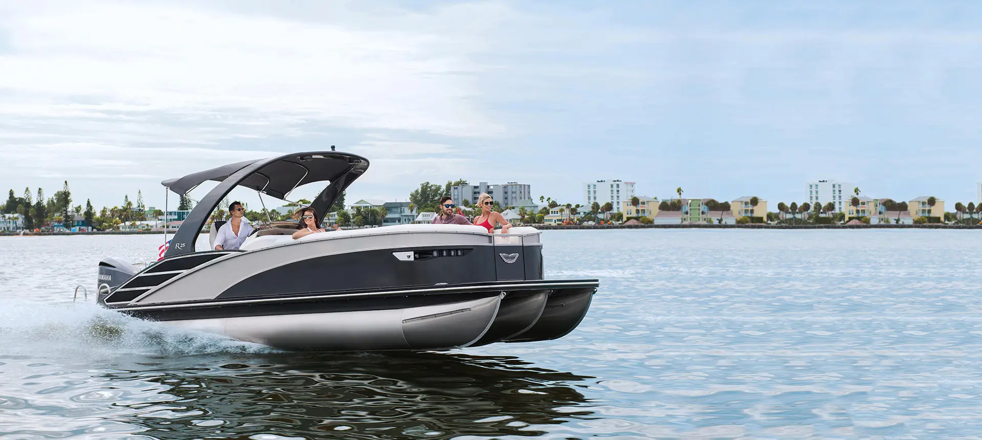 Bennington RX Sport pontoon boat cruising on a lake
